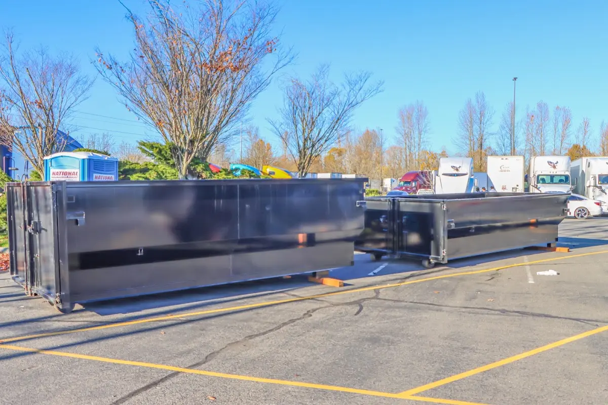 Professional dumpster rental service with roll-off container on residential driveway in Nashville